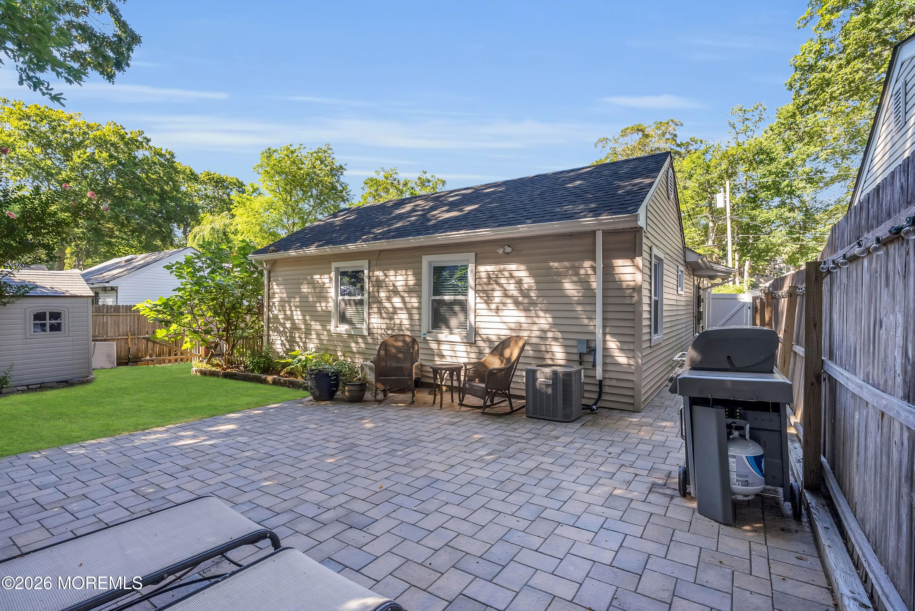 187 Pinecrest Road Oakhurst, NJ 07755 - Photo 26 of 26 a view of a patio with table and chairs near a garden
