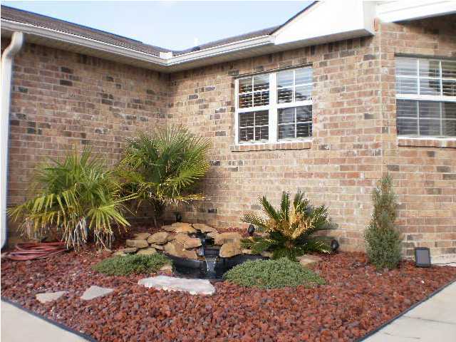 267 Limestone Circle Crestview, FL 32539 - Photo 2 of 9 a potted plant sitting in front of a house