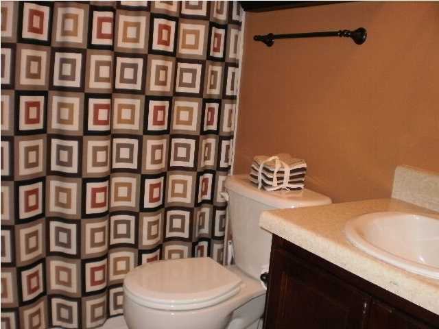 267 Limestone Circle Crestview, FL 32539 - Photo 8 of 9 a bathroom with a sink a toilet and shower curtain