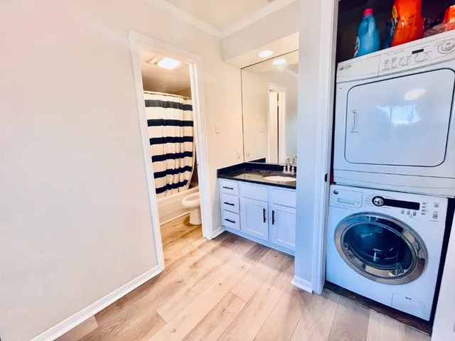 a view of a kitchen with cabinets and wooden floor