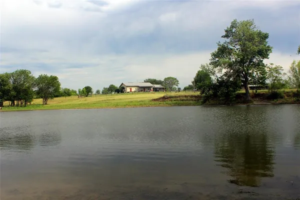 a view of a lake with houses in the back