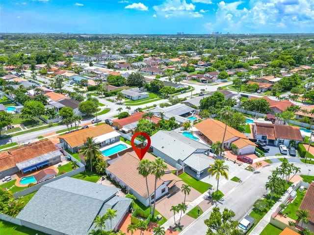 an aerial view of residential houses with outdoor space