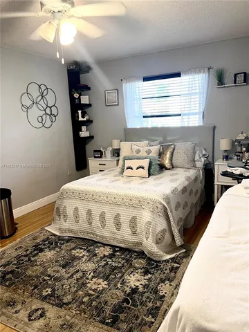 a bedroom with a bed a dresser next to a window