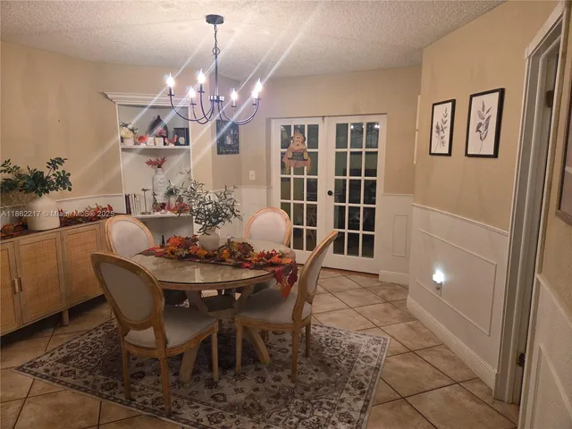 a view of a dining room with furniture and chandelier