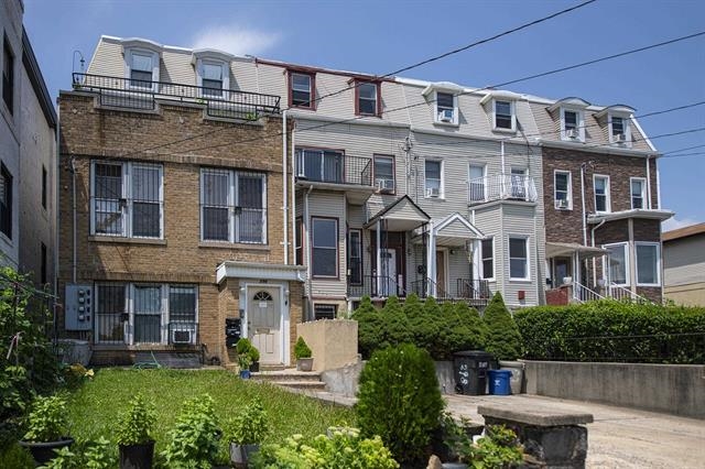 298 Paterson Plank Road Jersey City, NJ 07307 - Photo 6 of 13 a front view of a residential apartment building with a yard