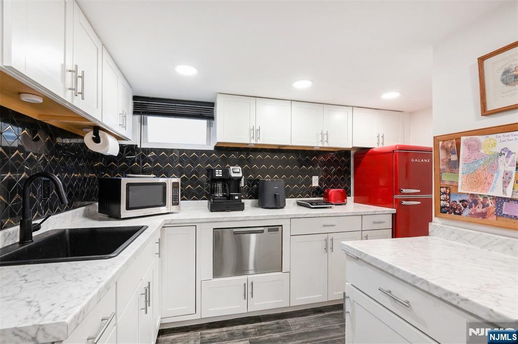 34 Lakeview Avenue Butler, NJ 07405 - Photo 19 of 30 a kitchen with stainless steel appliances granite countertop a sink stove and refrigerator