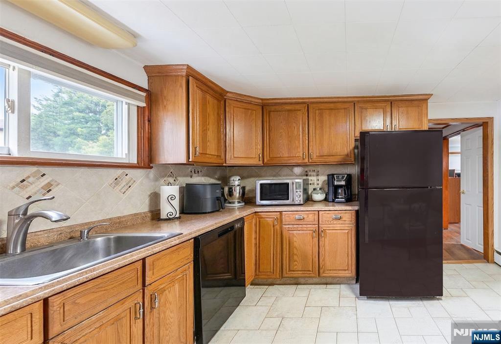 34 Lakeview Avenue Butler, NJ 07405 - Photo 21 of 30 a kitchen with stainless steel appliances granite countertop a refrigerator sink and cabinets