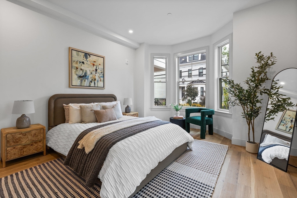 54 Springfield Street, Unit 1 Somerville, MA 02143 - Photo 12 of 38 a bedroom with bed and a potted plant