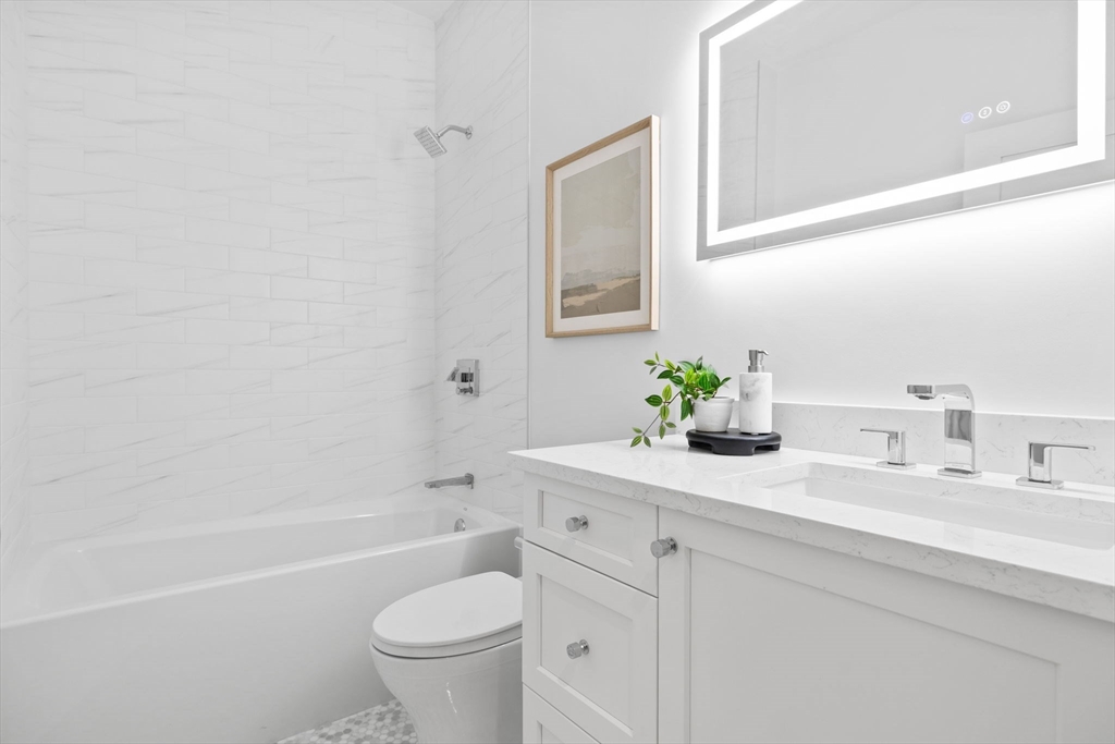 54 Springfield Street, Unit 1 Somerville, MA 02143 - Photo 16 of 38 a bathroom with a sink a toilet and a bathtub