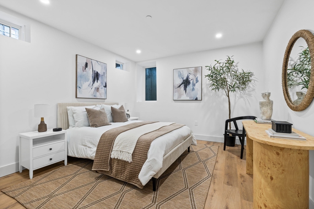 54 Springfield Street, Unit 1 Somerville, MA 02143 - Photo 22 of 38 a bedroom with a bed a couch and a window