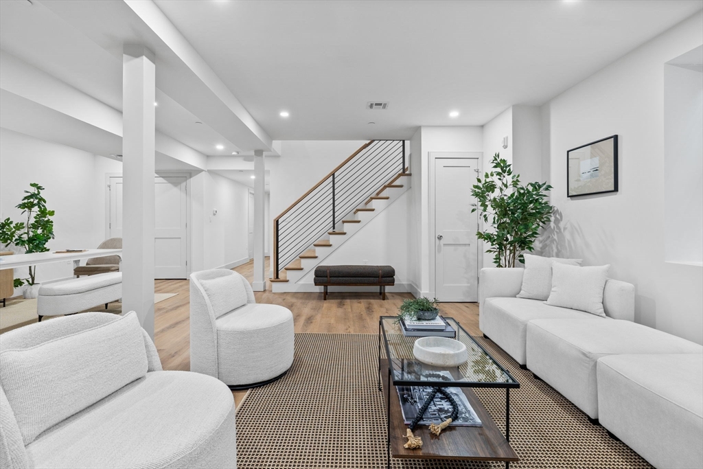 54 Springfield Street, Unit 1 Somerville, MA 02143 - Photo 23 of 38 a living room with furniture and a stairs