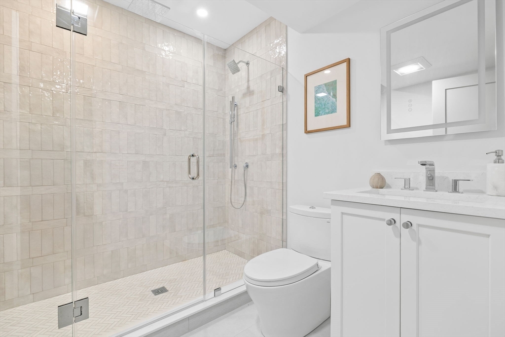 54 Springfield Street, Unit 1 Somerville, MA 02143 - Photo 27 of 38 a bathroom with a shower a toilet and sink