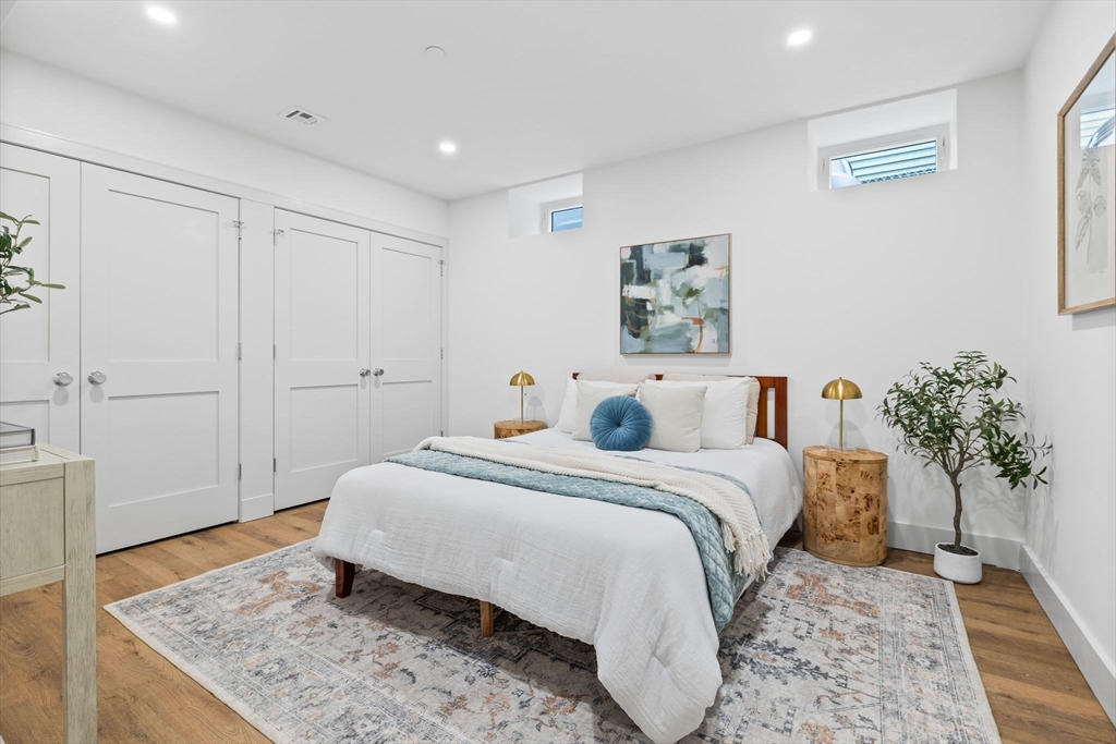 54 Springfield Street, Unit 1 Somerville, MA 02143 - Photo 28 of 38 a spacious bedroom with a bed and a potted plant