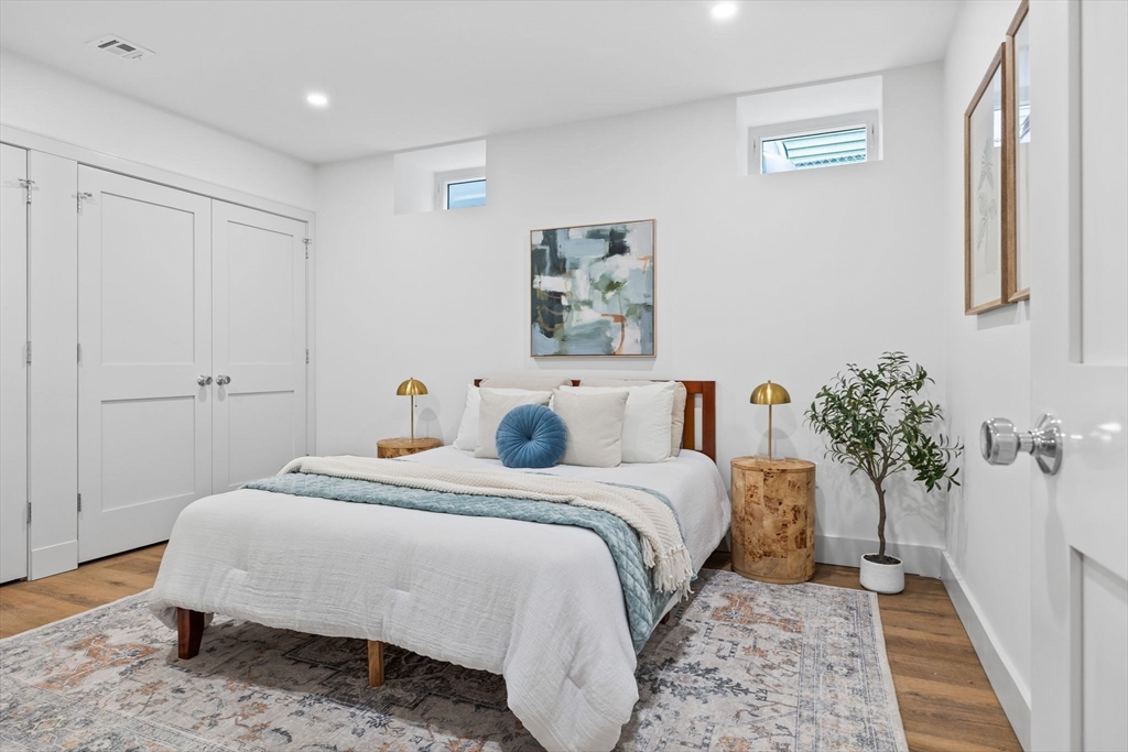 54 Springfield Street, Unit 1 Somerville, MA 02143 - Photo 29 of 38 a bed room with a bed and a potted plant