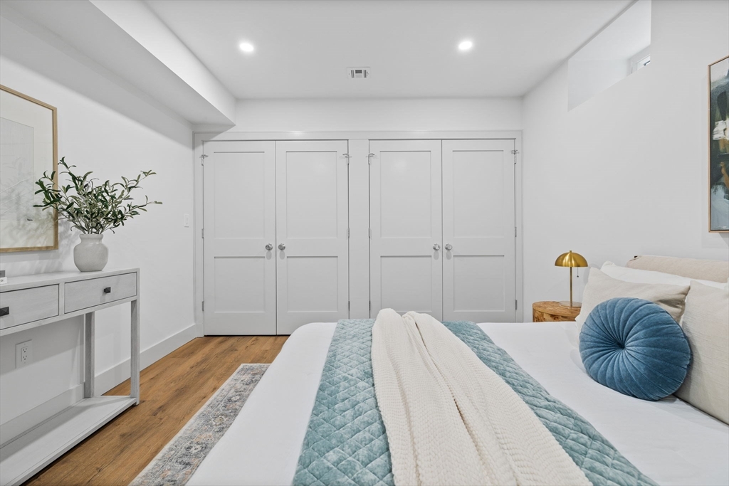 54 Springfield Street, Unit 1 Somerville, MA 02143 - Photo 30 of 38 a bedroom with a bed and a potted plant