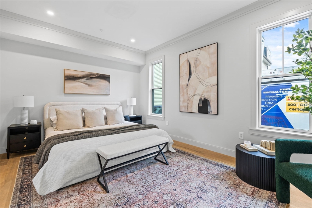 54 Springfield Street, Unit 1 Somerville, MA 02143 - Photo 34 of 38 a bedroom with a bed and a painting on the wall