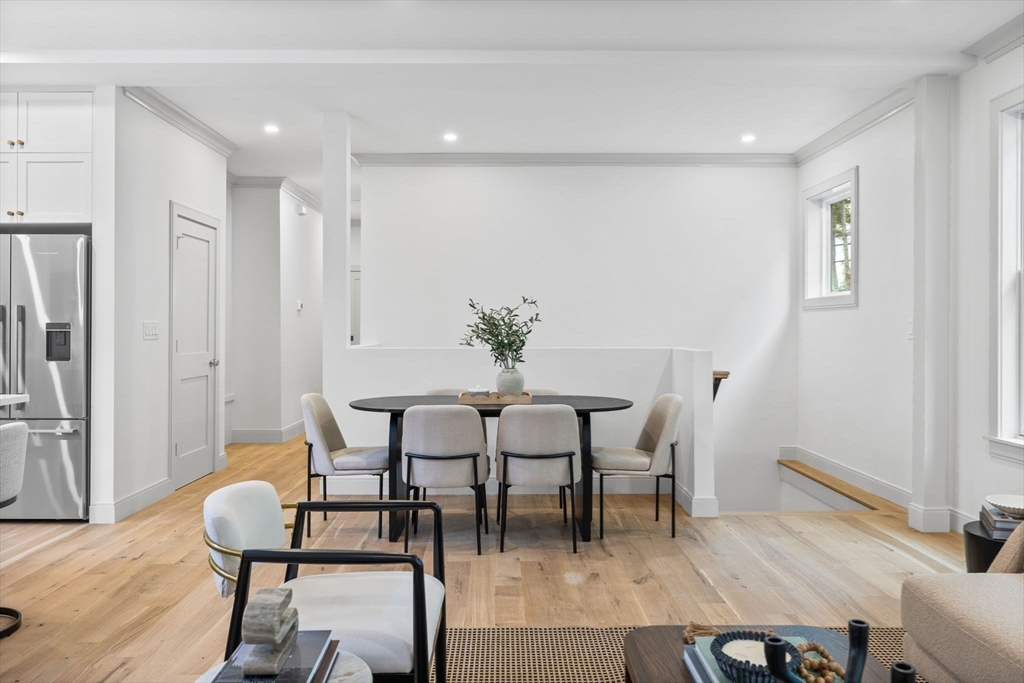 54 Springfield Street, Unit 1 Somerville, MA 02143 - Photo 8 of 38 a dining room with furniture and wooden floor
