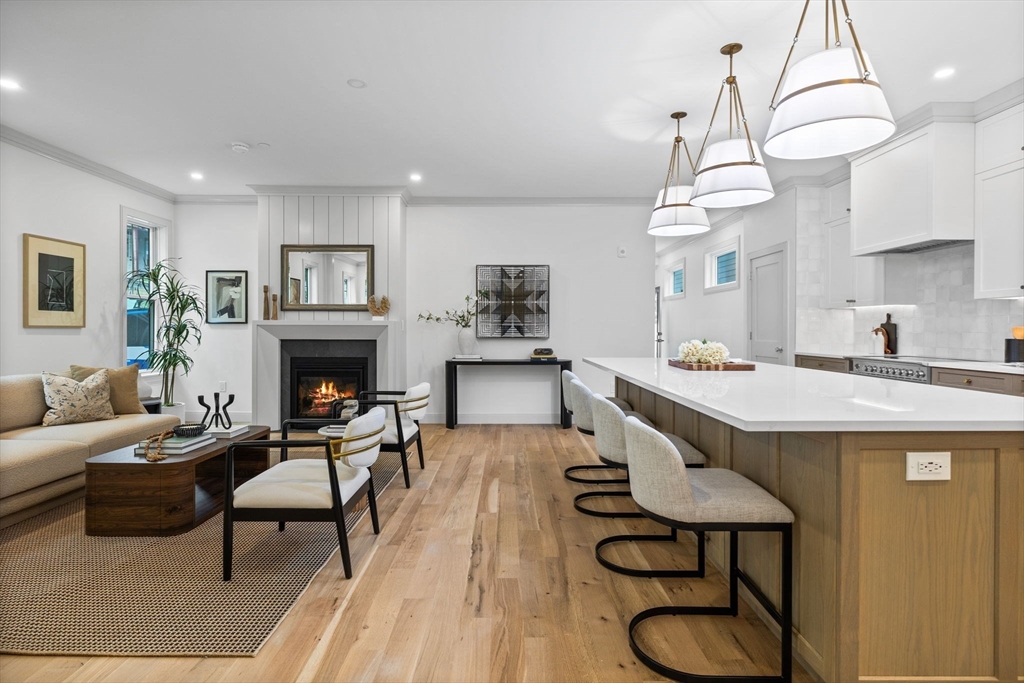 54 Springfield Street, Unit 1 Somerville, MA 02143 - Photo 9 of 38 a living room with furniture a table and a chandelier