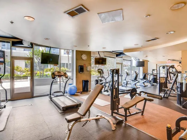 a view of a patio with a table and chairs and potted plants