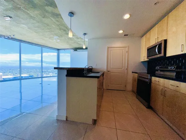 a kitchen with a sink stove and microwave