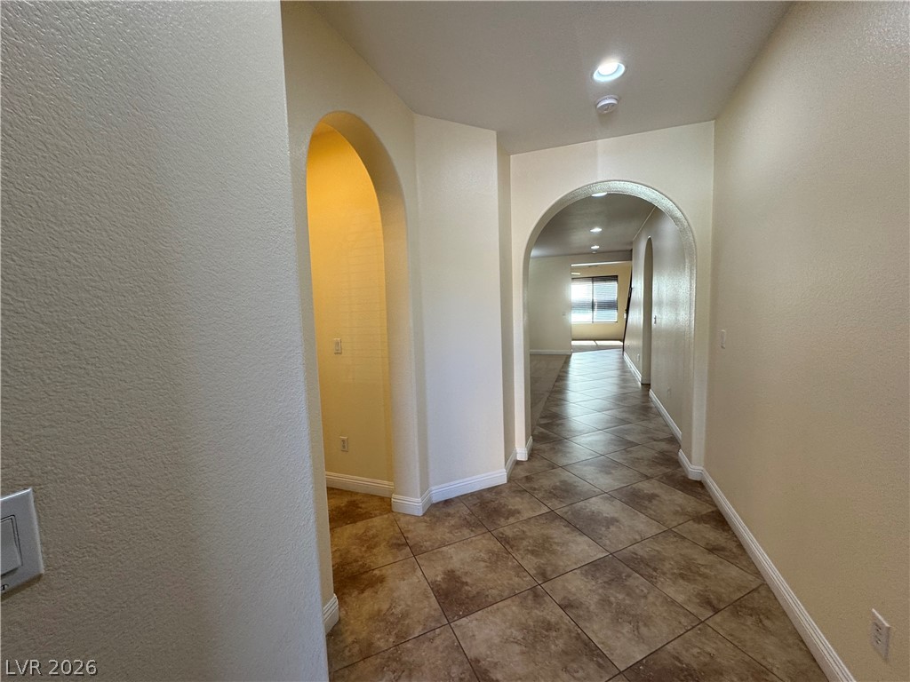 1333 Jamesbury Road Las Vegas, NV 89135 - Photo 2 of 43 Archways lead the way through this home, revealing an open layout with tiled flooring.