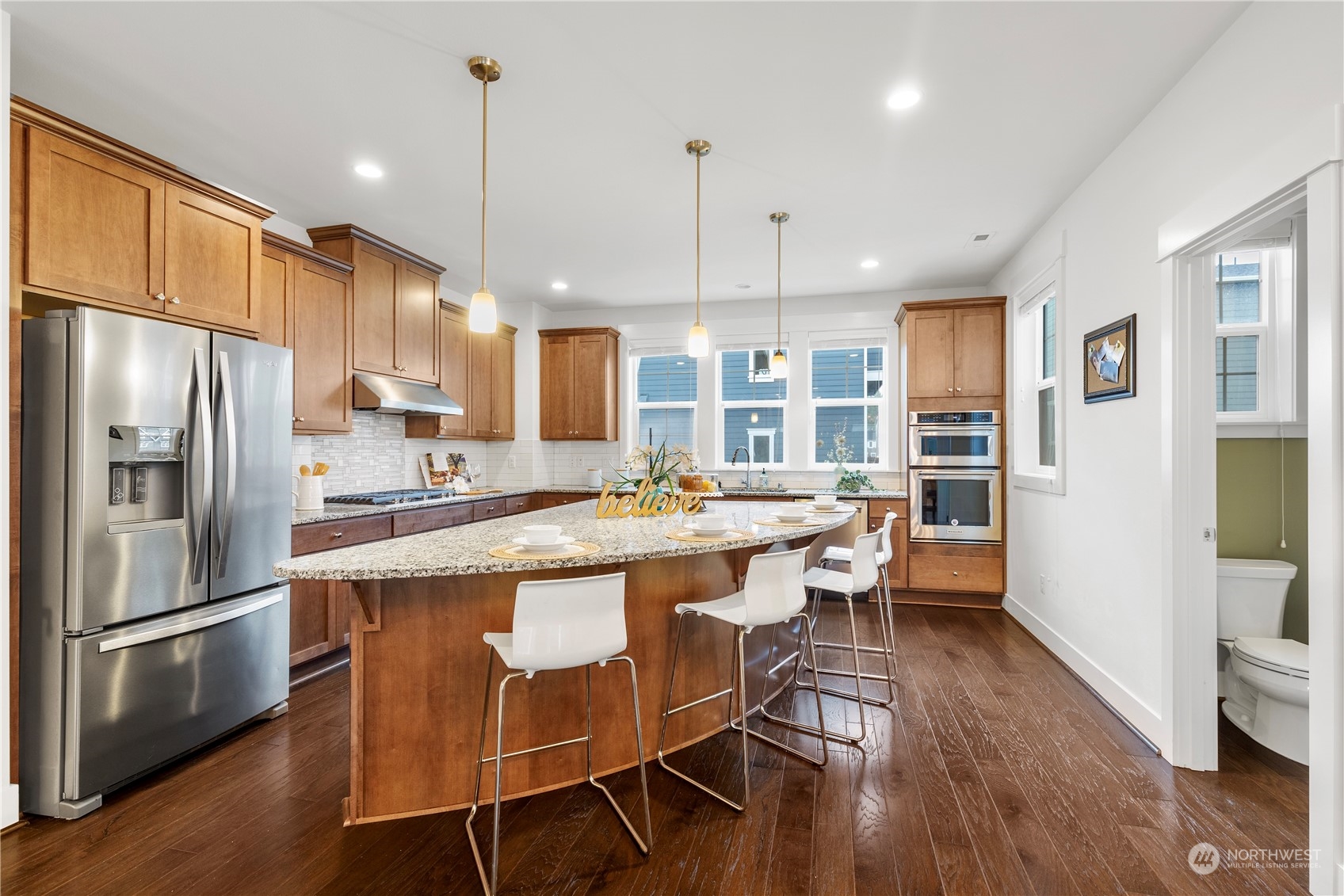 4524 186th Place Southeast, Unit A Bothell, WA 98012 - Photo 5 of 30 a kitchen with stainless steel appliances granite countertop a table chairs refrigerator and microwave