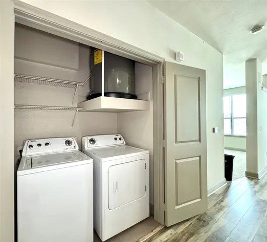 a view of washer and dryer with wooden floor