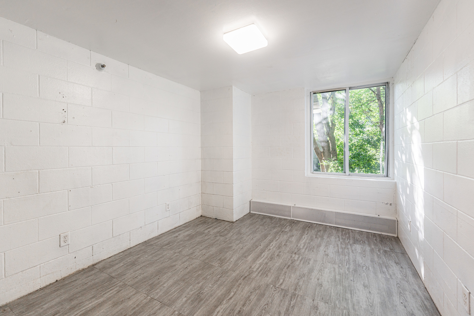 919 Greenbrier Road DeKalb, IL 60115 - Photo 11 of 23 an empty room with wooden floor and windows