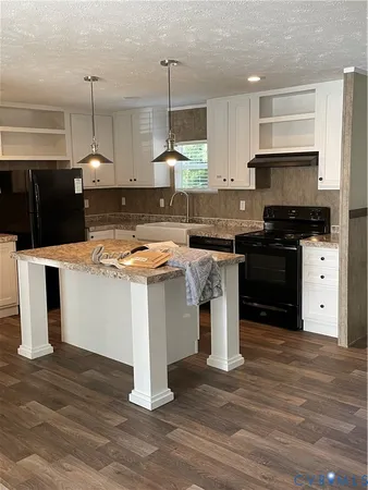 a kitchen with a stove and a kitchen island