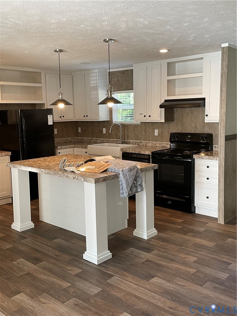 24911 Rainey Creek Road McKenney, VA 23872 - Photo 11 of 20 a kitchen with a stove and a kitchen island