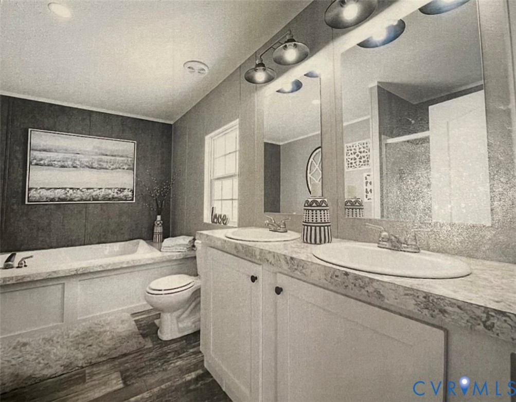 24911 Rainey Creek Road McKenney, VA 23872 - Photo 15 of 20 a bathroom with a double vanity sink toilet mirror and bathtub
