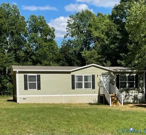 a house that has a big yard in front of it