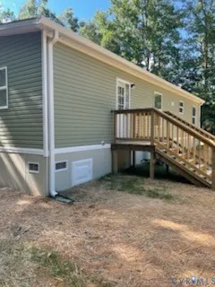 a view of backyard with deck and seating area