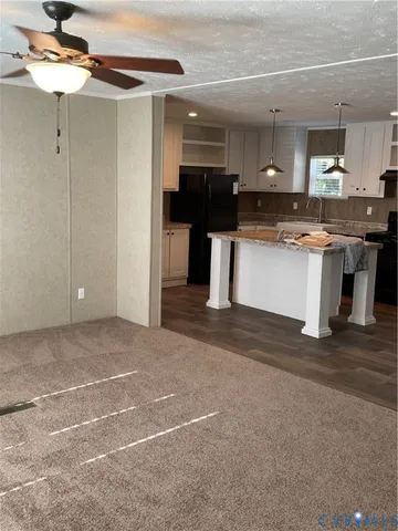 a view of kitchen with refrigerator and window