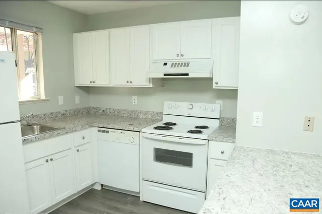 a kitchen with cabinets appliances and a sink