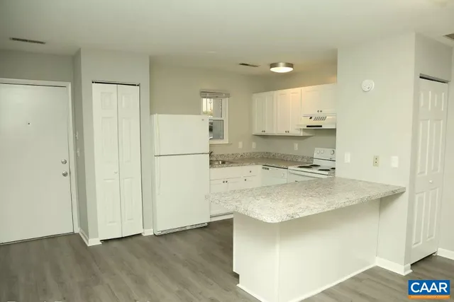 a kitchen with kitchen island a sink stainless steel appliances and cabinets