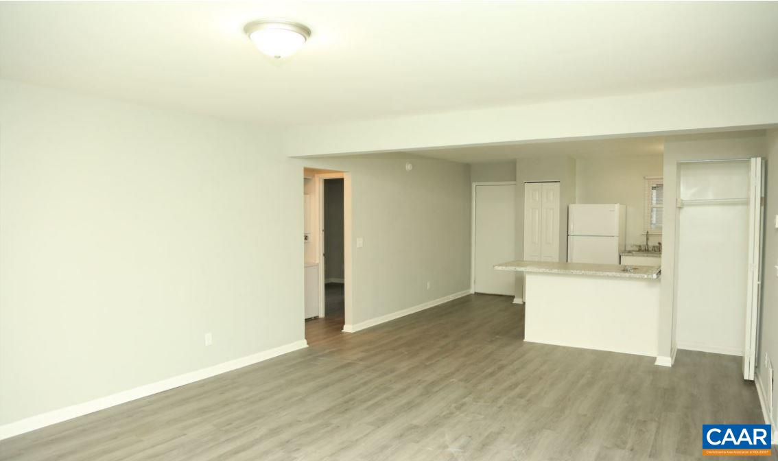 101 Westerly Avenue Charlottesville, VA 22903 - Photo 5 of 10 a view of an empty room and kitchen with wooden floor