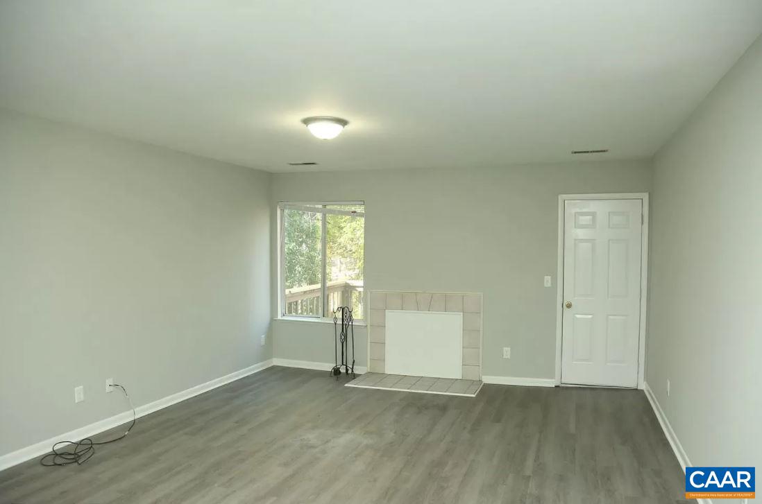 101 Westerly Avenue Charlottesville, VA 22903 - Photo 6 of 10 an empty room with wooden floor and windows