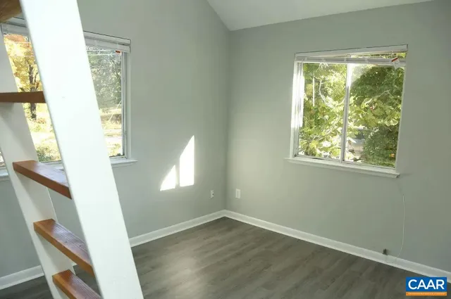 a view of an entryway with wooden floor and windows