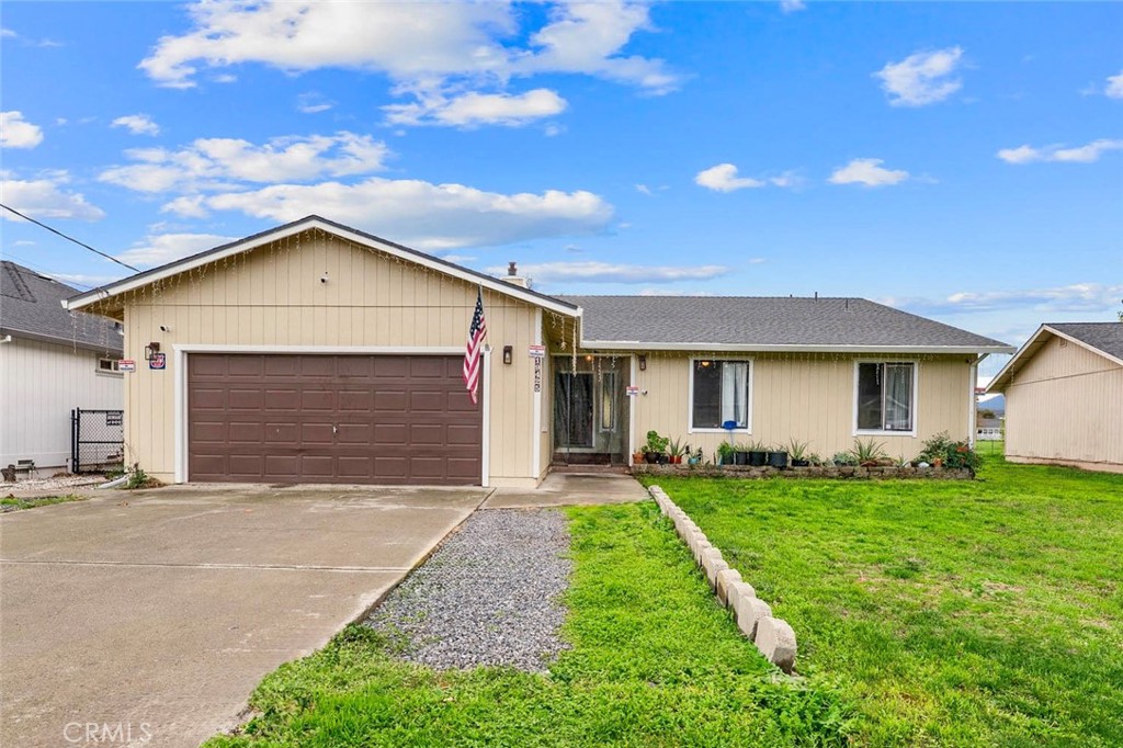 19425 Old Creek Road Hidden Valley Lake, CA 95467 - Photo 1 of 42 a front view of a house with a yard and garage
