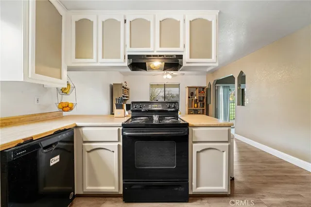 a kitchen with granite countertop a stove and a sink