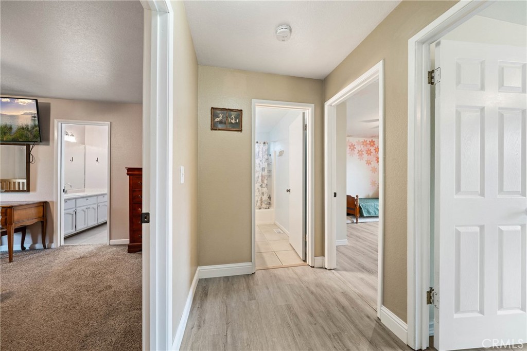 19425 Old Creek Road Hidden Valley Lake, CA 95467 - Photo 18 of 42 a view of a hallway with bathroom and wooden floor