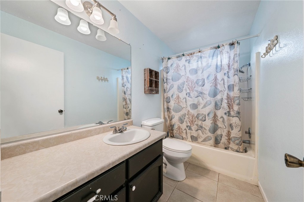 19425 Old Creek Road Hidden Valley Lake, CA 95467 - Photo 21 of 42 a bathroom with a sink a toilet and shower curtain