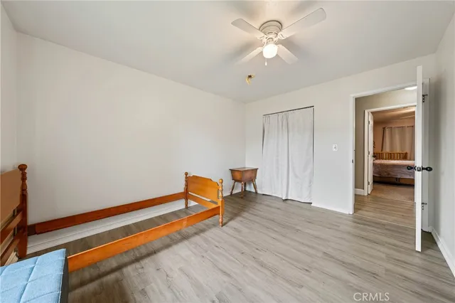 a view of room with wooden floor and ceiling fan