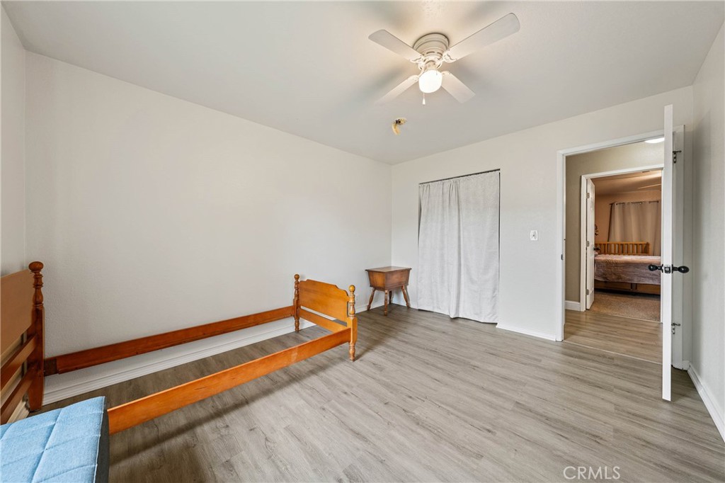 19425 Old Creek Road Hidden Valley Lake, CA 95467 - Photo 27 of 42 a view of room with wooden floor and ceiling fan