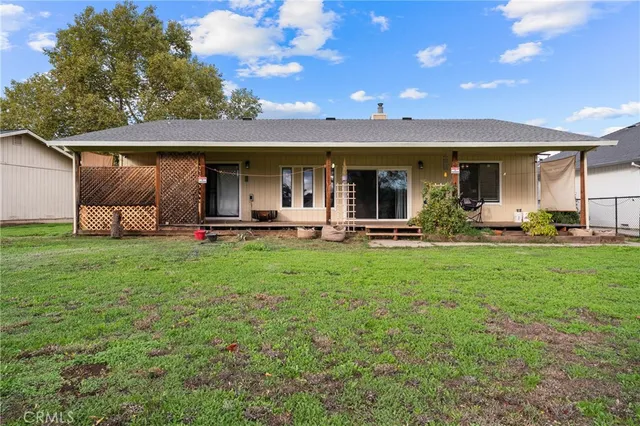 a view of a house with backyard and porch