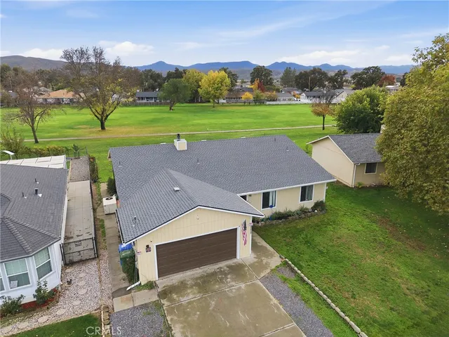 an aerial view of a house with big yard