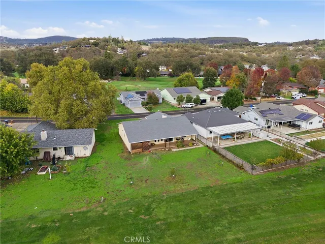 an aerial view of residential houses with outdoor space and river