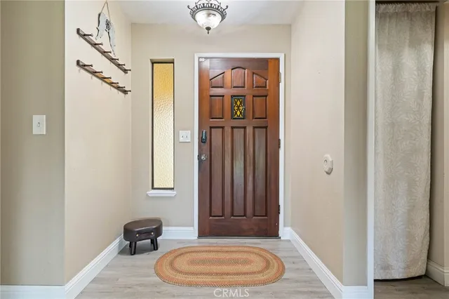 a view of a bedroom with furniture and wooden floor