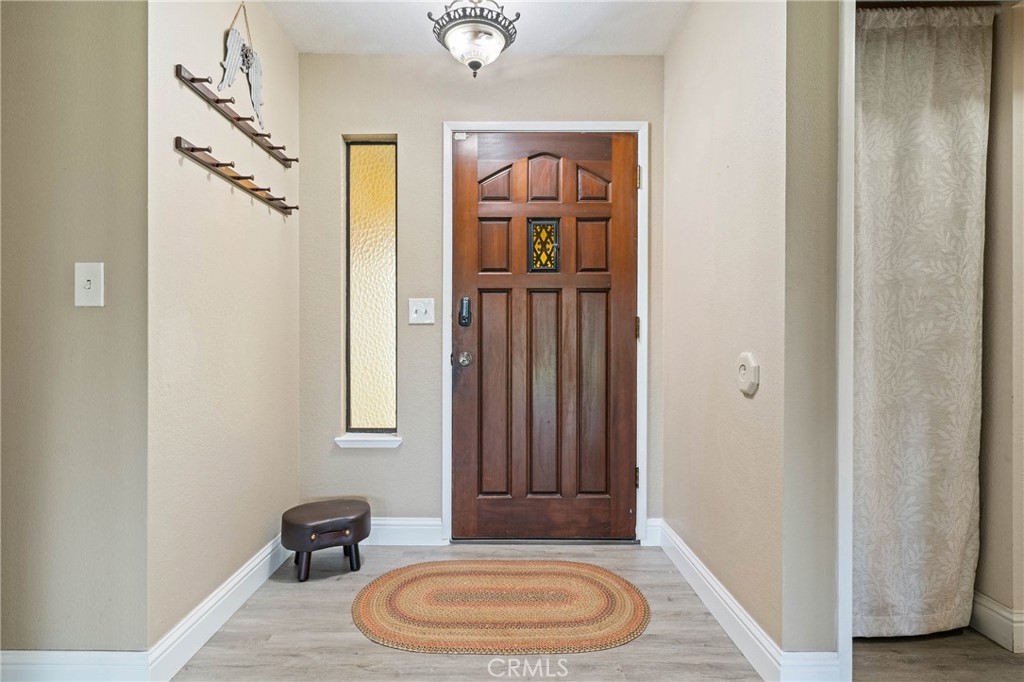19425 Old Creek Road Hidden Valley Lake, CA 95467 - Photo 7 of 42 a view of a bedroom with furniture and wooden floor